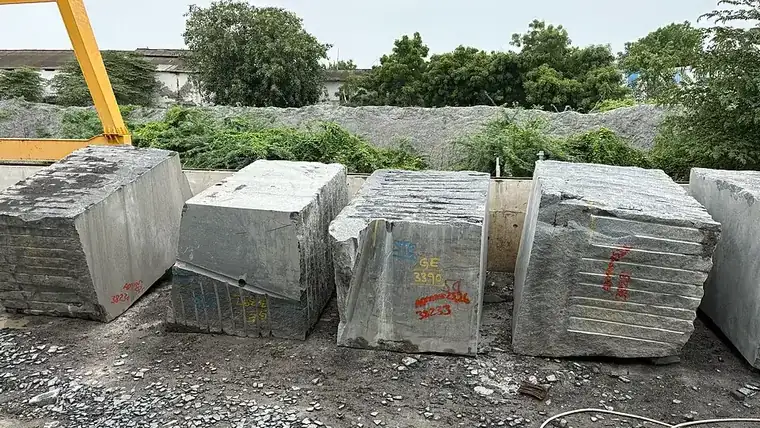 Rough granite blocks stacked in a stone yard in India