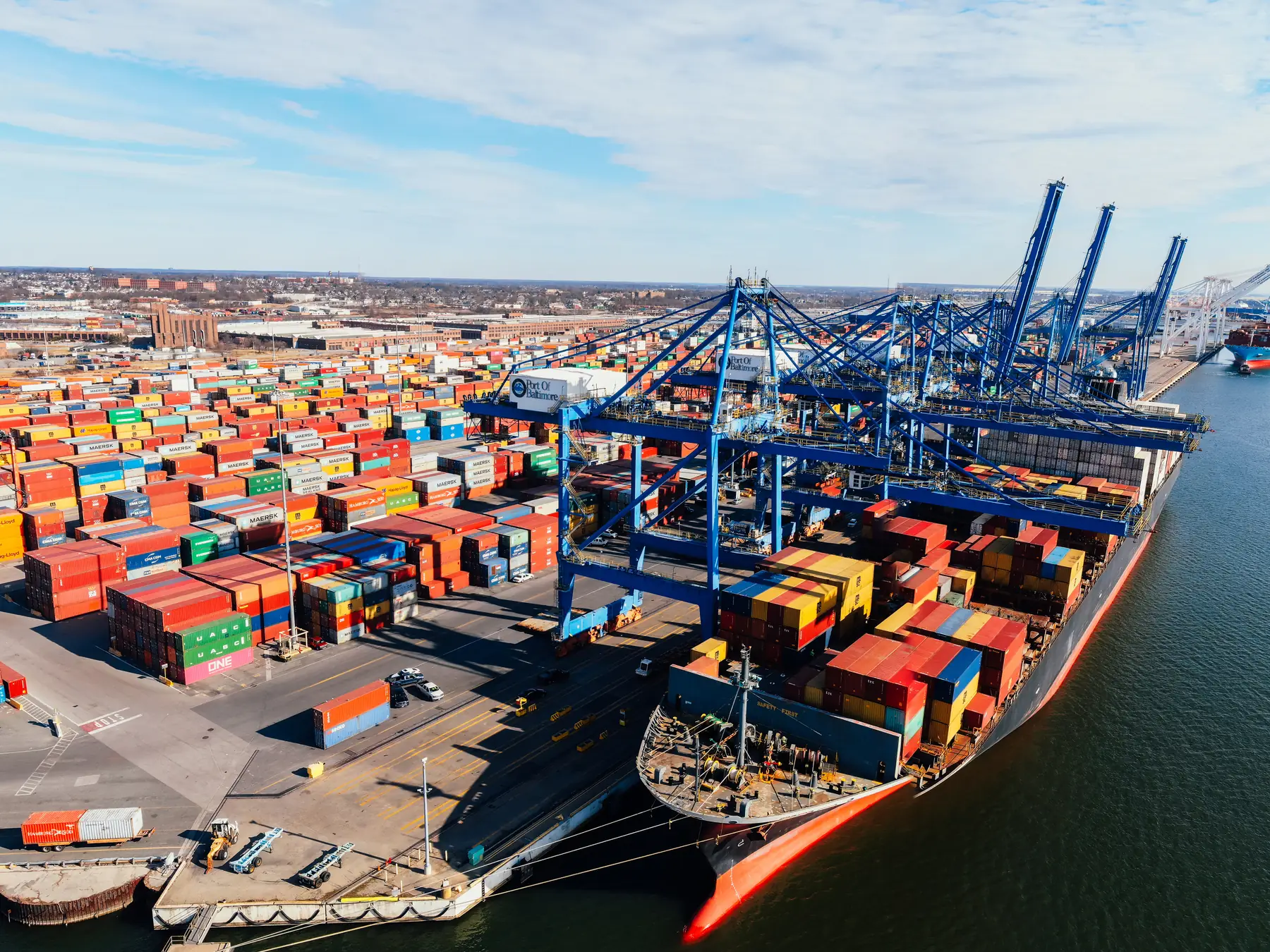 Container port with cranes loading a vessel