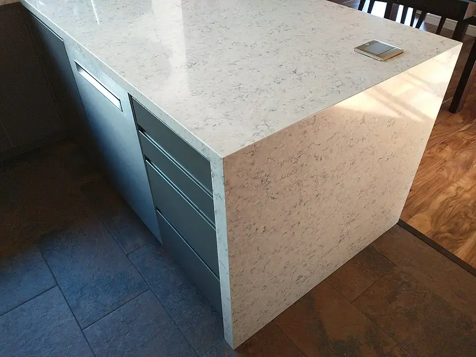 Kitchen island with a quartz waterfall countertop